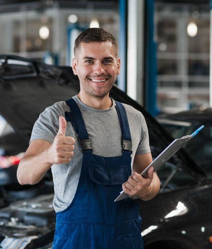 Smiling technician giving a thumbs up with a clipboard